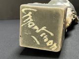 a close up of a metal object with writing on it