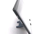a tablet computer sitting on a stand on a white surface