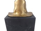 statue of a cat sitting on a black marble block