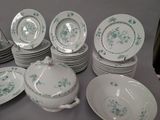 a lot of plates and bowls that are on a table