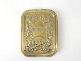 an image of a gold plate with a skull and flowers on it