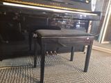 a black piano sitting next to a black piano