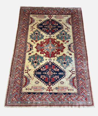 an antique persian rug with a blue, red, and white design