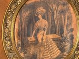a picture of a woman in a dress on the wall
