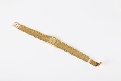 an image of a gold watch on a white surface