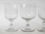 three wine glasses sitting next to each other on a table