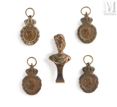 four bronze medals and a bust of a woman