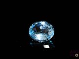 a close up of a blue topaz gems on a black surface