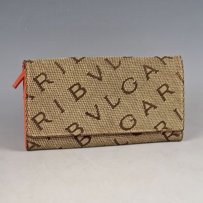 beige and orange purse with a hello kitty design