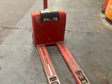 a red forklift sitting in the middle of a warehouse floor