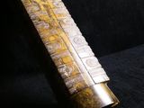 an old brass instrument that is sitting on a black surface
