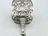 an antique silver purse with a bell hanging from it ' s side