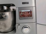 a silver mixer sitting on a white counter top