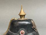 an old black helmet with a gold crown on top