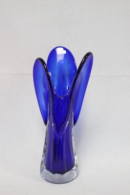a blue glass vase with a blue angel on it