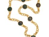 a close up of a gold chain with roman coins on it