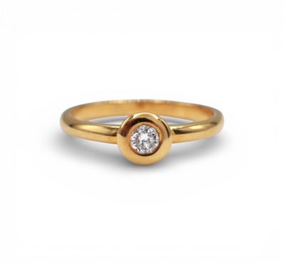 a gold ring with a single diamond in the center