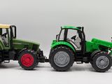 two toy tractors that are sitting next to each other