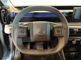 the interior of a car with a steering wheel and dashboard controls