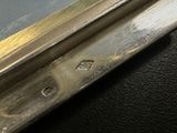 a close up of a piece of metal on a black surface