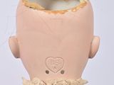 a doll that has a head on it ' s head
