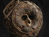 une image représentant un crâne entouré d'une corde, sur fond noir