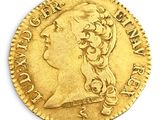 a close up of a gold coin on a white surface