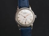 a close up of a wrist watch on a black background