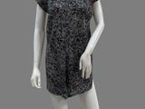 female mannequin in a black and white dress on a gray background