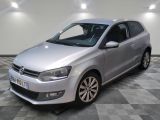 la volkswagen polo argentée est garée sur un carrelage à carreaux