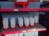 a shelf with several bottles of water on it in a store