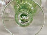 a close up view of a glass with a green liquid inside of it