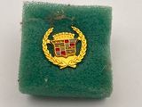 a green sponge pad with a red and gold badge on it