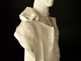 marble bust of a man in a suit on a black background