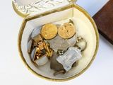 a small box with a bunch of coins inside of it