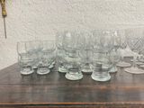 a lot of glasses sitting on a wooden table