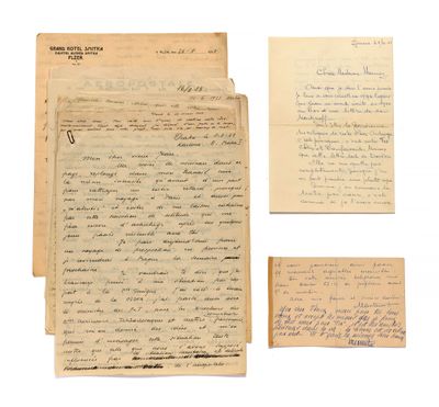 a group of old papers and a piece of paper on a white surface