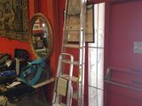 a ladder leaning up against a red wall in a room