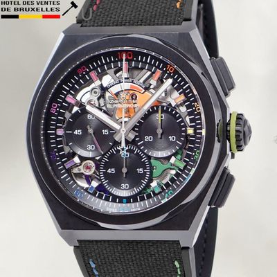 a close up of a watch with a black face
