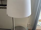 a glass table with a lamp on top of it