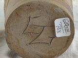 a close up of a piece of wood with a tag on it