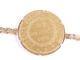 an image of a close up of a gold coin on a chain