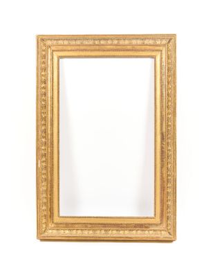a gold framed mirror against a white wall