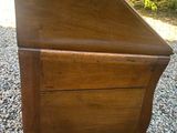 an old wooden desk with a drawer on top of it