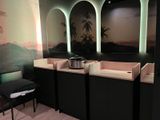 three sinks and a chair in a bathroom with a mural on the wall