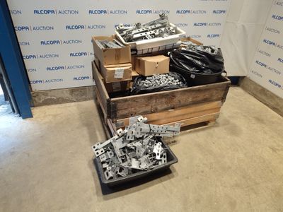 a pile of assorted metal parts in a wooden crate