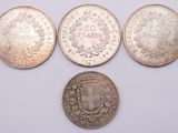 four different coins are shown on a white surface