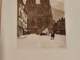 a black and white photo of a man and a dog in front of a cathedral