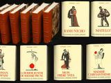 Plusieurs livres sont alignés sur une table devant un fond noir.