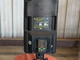 a picture of an orange and black forklift in a warehouse